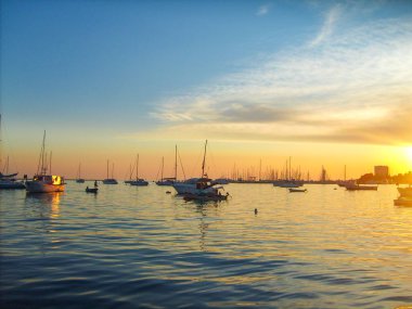Sunset over the harbor with moored boats