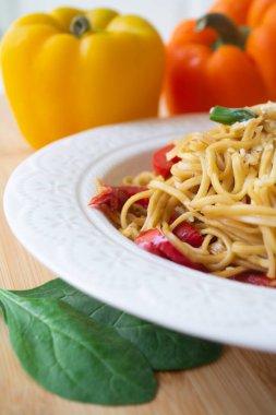 Soya soslu Çin yumurtalı şehriye, renkli dolmalık biber, yeşillik ve üzerine susam tohumları serpiştirilmiş taze soğan.