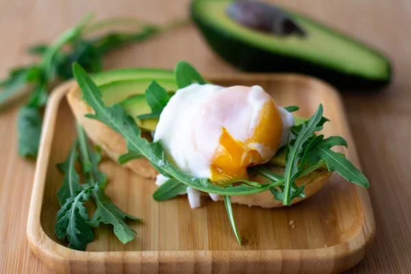 Stylish Healthy Breakfast Avocado Arugula Poached Egg Toast Wooden Surface — Stock Photo, Image