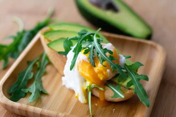 Stylish Healthy Breakfast Avocado Arugula Poached Egg Toast Wooden Surface — Stock Photo, Image