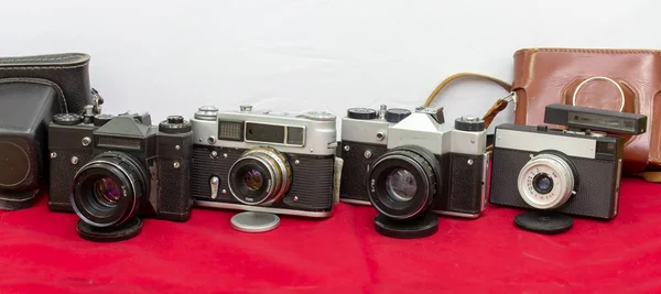 four Film cameras in-line made in the Soviet era, they work fine and now