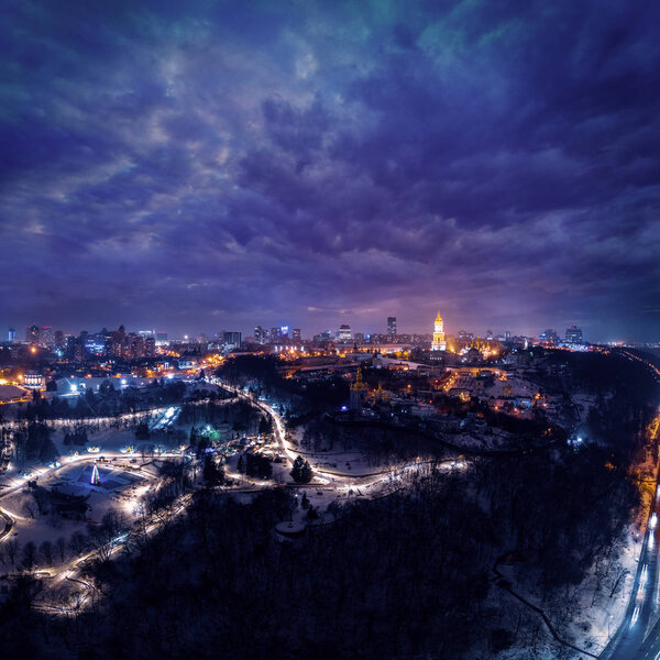 Panoramic aerial view of the night winter Kiev with a clearly marked highway road along the Dnieper River