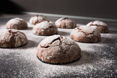 Lezzetli çikolata kurabiye güzel çatlaklar ile chip ve krema şeker koyu arka plan üzerinde ile tozunu.