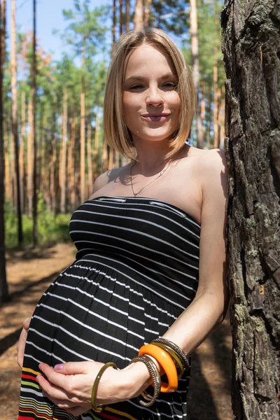 Pregnant woman in the forest