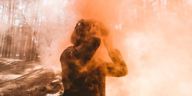 Kadın düz turuncu ile duman sis bombası arıyorum sanal gerçeklik kulaklık ile ormanda