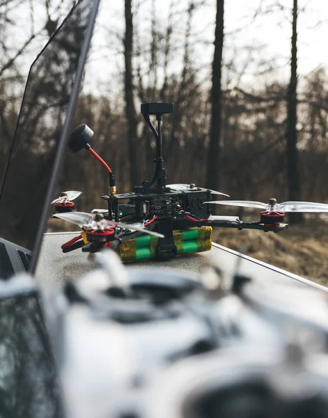 Drone FPV se trouve sur la table près de l'ordinateur portable et le panneau de commande . — Photo