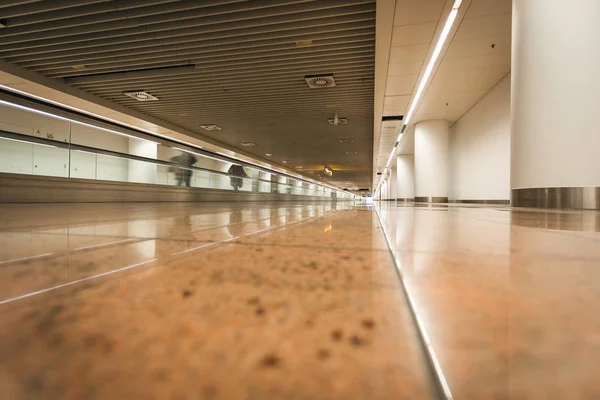 Modern airport hall interior with blurred people walking