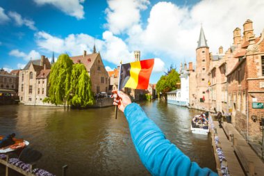 Bruges, Belçika'daki ilgi çekici yerlerin arka planına karşı Belçika Bayrağı