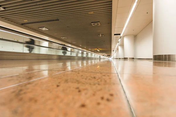 Modern airport hall interior with blurred people walking
