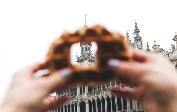 Vista da King House ou do Museu da Cidade de Bruxelas na Grand Place, em Bruxelas, através de um buraco no tradicional waffle belga . — Fotografia de Stock