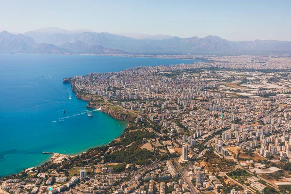 Window view of an airplane on the coast of Antalya with beautiful Taurus Mountains on the horizon, Turkey