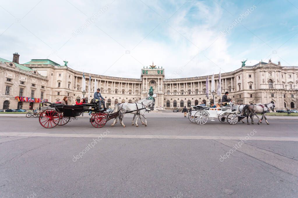 Hofburg Palace and Heldenplatz with a passing carriage with a pair of horses, Vienna, Austria