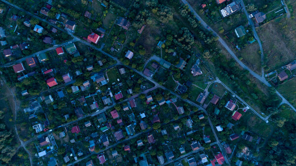 Top view of the village with private houses at sunset. Aerial view