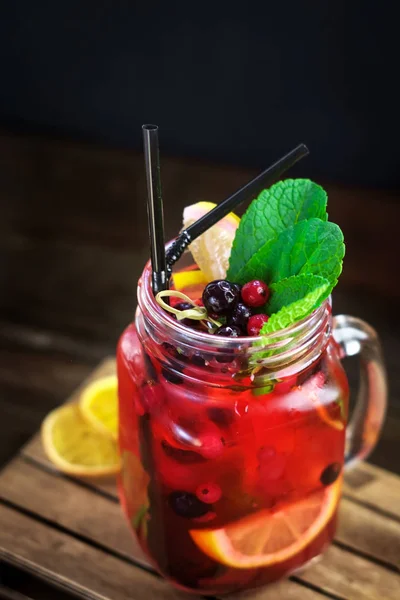 Lemonade cranberry and black currant on wooden background