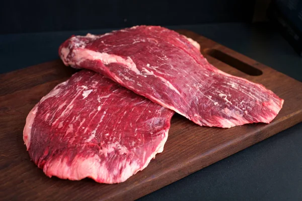 Ruwe flank rundvlees op een houten bord — Stockfoto
