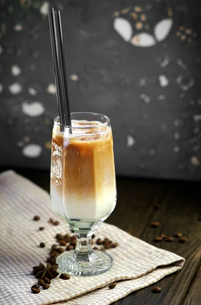 cool coffee frappe with caramel in glass Cup on wooden backgroun