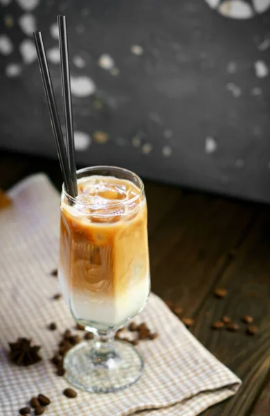 cool coffee frappe with caramel in glass Cup on wooden backgroun