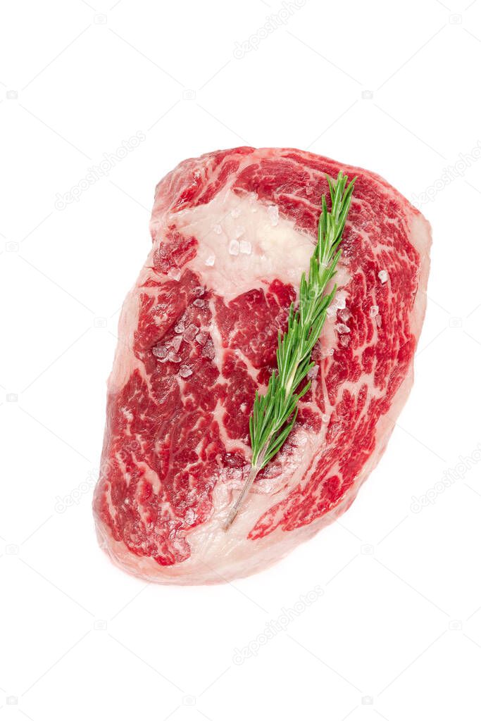 Raw rib eye steak marbled beef with salt and rosemary isolated on white background