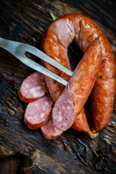 Bavarian smoked sausages from pork cut on a wooden Board. Rustic style