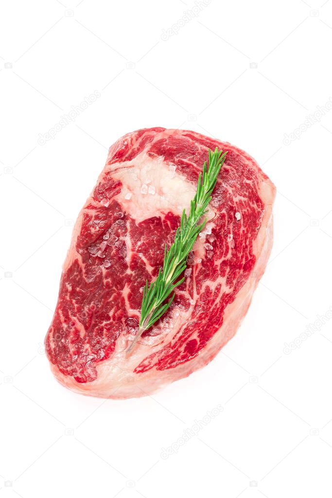 Raw rib eye steak marbled beef with salt and rosemary isolated on white background