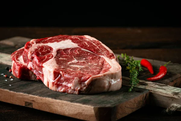 Fresh Raw Beef Rib Eye Steak Red Pepper Herbs Wooden — Stock Photo, Image