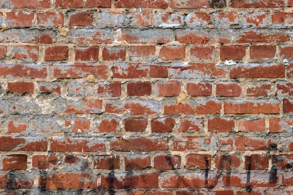 Grungy Exterior Brick Wall With Black Graffiti