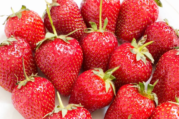 Close-up view of delicious strawberries on white background