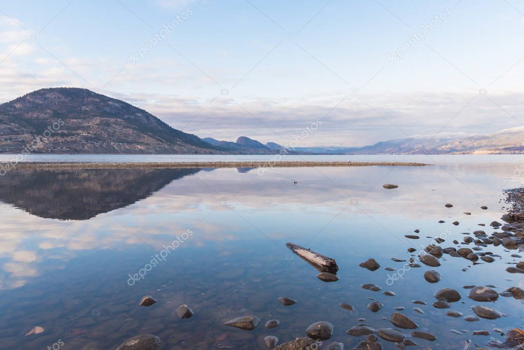 Reflection of clouds and mountains on Okanagan Lake in winter