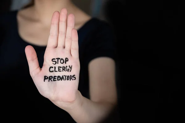 Woman holding out hand with words Stop Clergy Predators written on palm — Stock Photo, Image