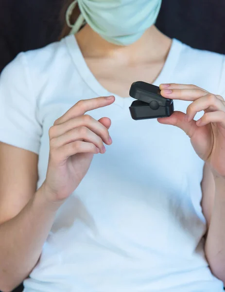 Causian Woman Wearing Face Mask Putting Pulse Oximeter Finger Stock Picture