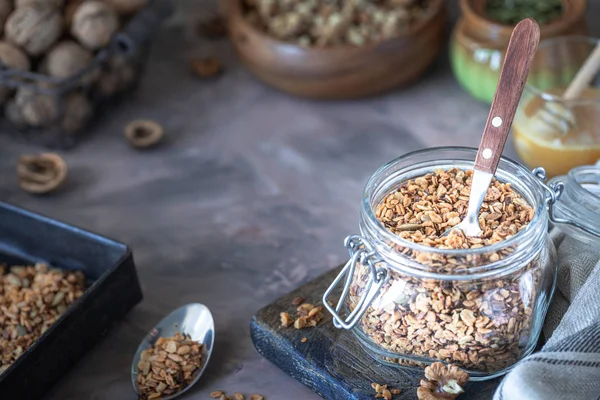 Sağlıklı kahvaltı için cam kavanozda fındık ve çekirdekli ev yapımı granola.