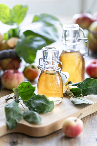 Apple vinegar. Bottle of apple organic vinegar or cider on wooden background. Healthy organic food.