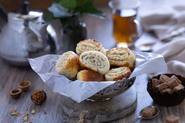 Oriental pastry made from puff pastry and wrapped in it a filling of sugar, butter and walnut. Armenian national pastry ghat or kyat with New Year\'s serving.. Selective focus