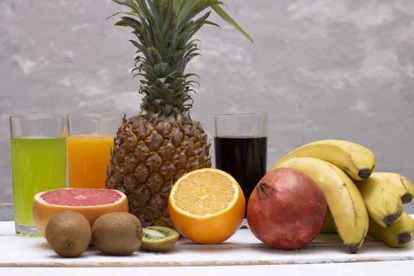 whole pineapple and fruits for breakfast, chalk background