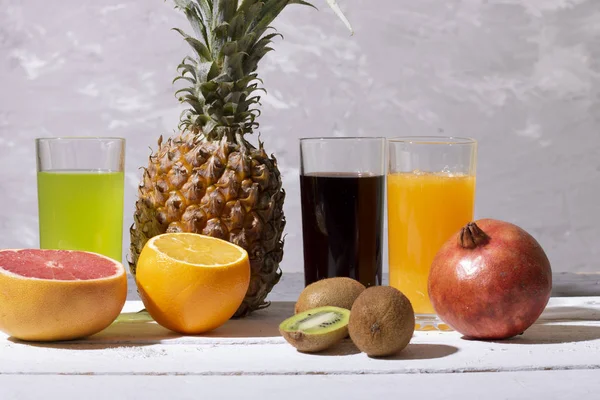 fresh juices and smoothie from fruits, chalk background