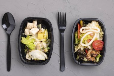 salad with chicken and vegetables on a white plate. top view.