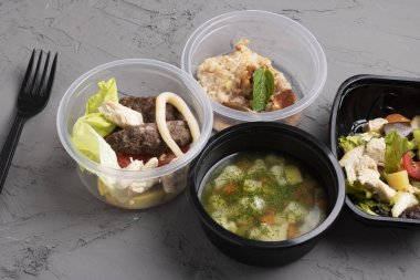chicken and vegetables in a plate on a white background