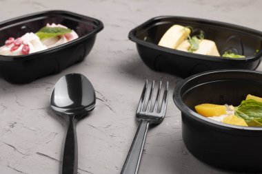 close up view of delicious salad with vegetables and chopsticks on table