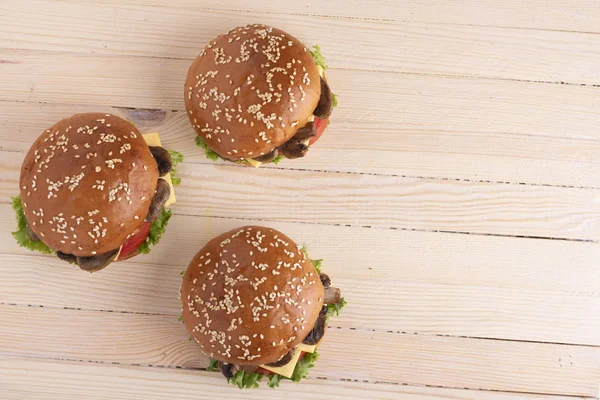 hamburger buns with sesame and raw vegetables, top view