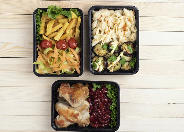 top view of ready meal into food containers, fried zucchini and eggplants, place for text