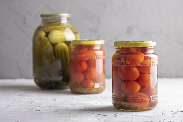 Canned vegetables in three glass jars, closeup. With dill and garlic — Stock Photo, Image