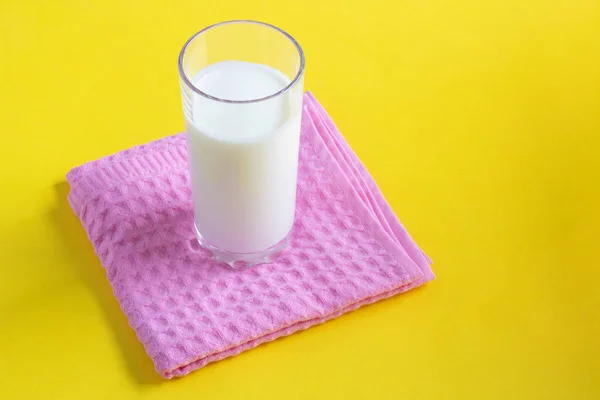 Milk on the yellow background. Minimal concept