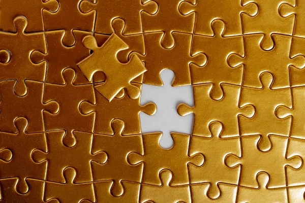 missing golden puzzle piece, top view. Money and success concept