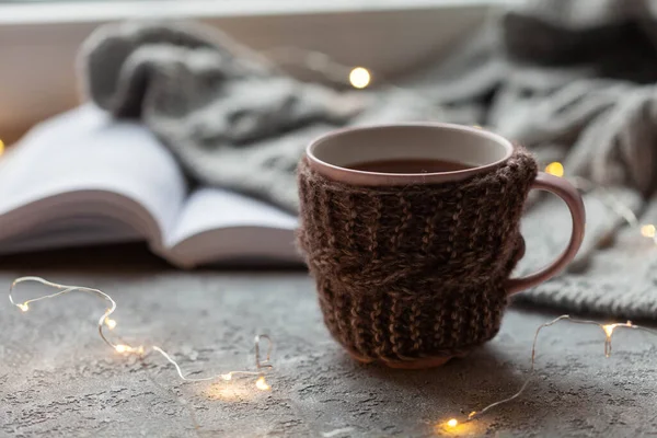 Pencere kenarında bir fincan sıcak çay, kızlık zarı konsepti, yakın plan.