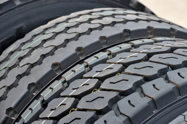 Big truck wheel a black tires closeup