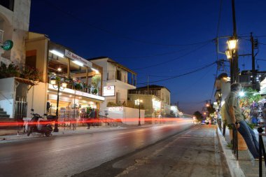Platanias, Crete - August 24: Street after sunset in Platanias, Crete on August 24, 2018. Platanias is a village and municipality on the Greek island of Crete clipart
