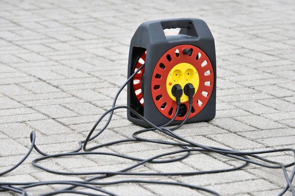 Electrical extension cord with plugs