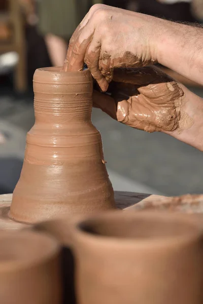 Pottery male ceramist creates a hand made clay product