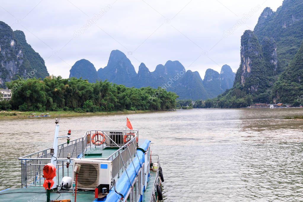 Karst peaks in Xingping Town and pleasure boat on the Li River known as Lijiang River.