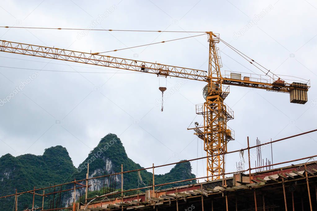 Tower crane on a background karst peak in chinese city Xingping